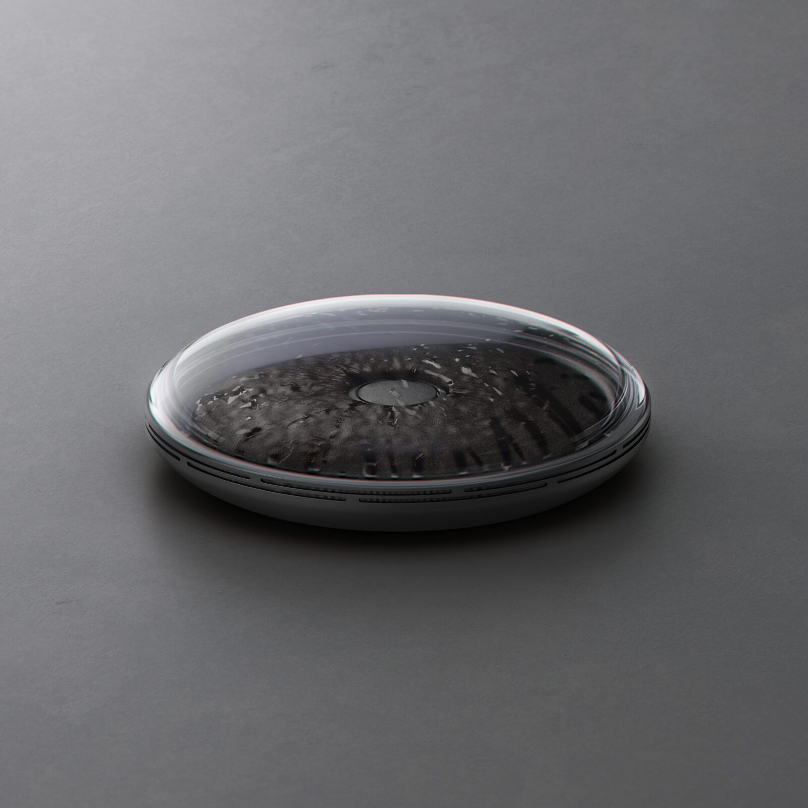 BioScensor Totale Ansicht des BioScensors. Der runde Sensor besitzt einen Glasdeckel an dem sich Feuchtigkeit absetzt. Im Inneren ist die schwarze Schleimhaut zu erkennen, über die die Düfte analysiert werden können.