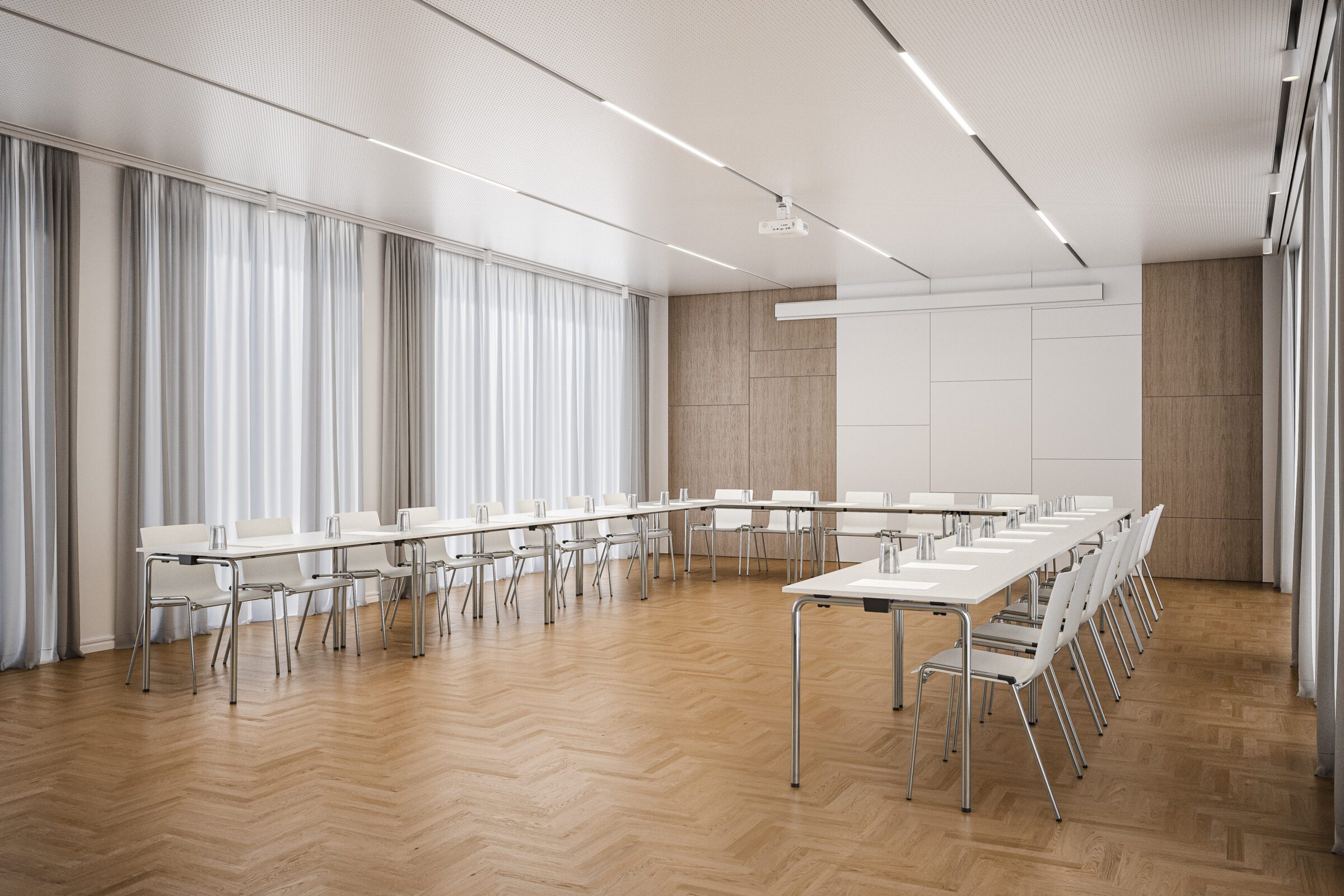 Seminarraum mit Leinwand im Hintergrund. Die Tische 1196 sind in der Form des Buchstaben U aufgestellt und ermöglichen eine Kommunikationssituation.